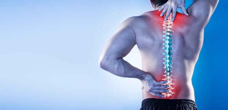 A man gripping his lower back, showcasing a color-gradient spine graphic that transitions from blue to red, indicating pain or discomfort in the lumbar area against a blue backdrop