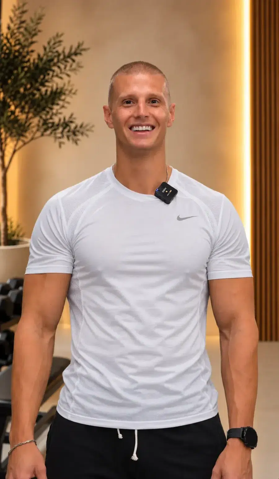 Mike, personal trainer in Dubai, smiling in a gym